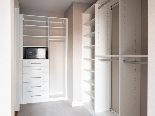 a view of walk in closet with empty racks