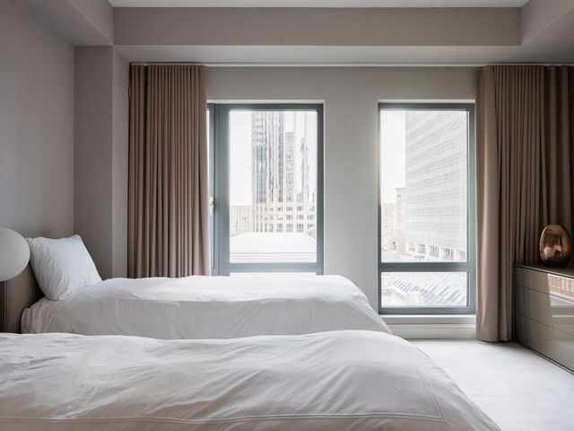 a bedroom with a large bed and a large window