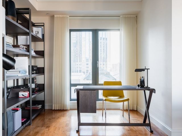 a living room with furniture a rug and a large window