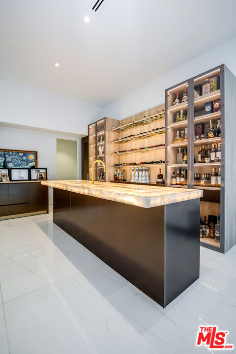 16601 Park Ln Circle Los Angeles, CA 90049 - Photo 11 of 69 a kitchen with stainless steel appliances kitchen island granite countertop a refrigerator and a stove