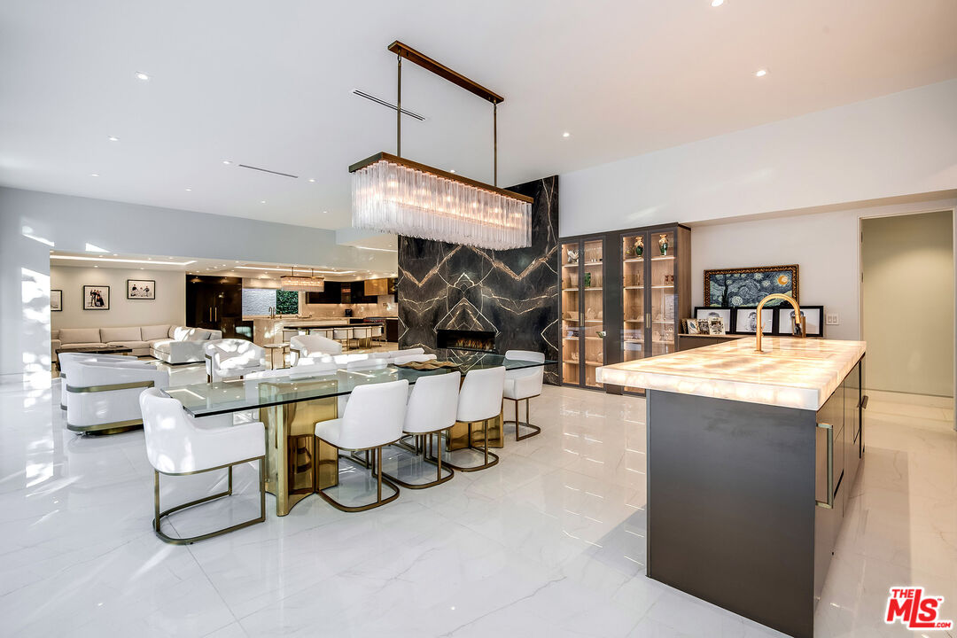 16601 Park Ln Circle Los Angeles, CA 90049 - Photo 14 of 69 a room with lots of table and chairs