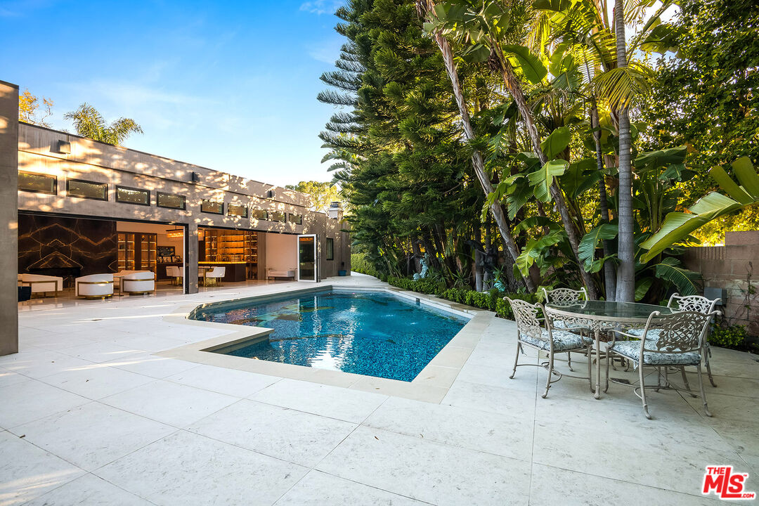 16601 Park Ln Circle Los Angeles, CA 90049 - Photo 24 of 69 a view of a patio with swimming pool