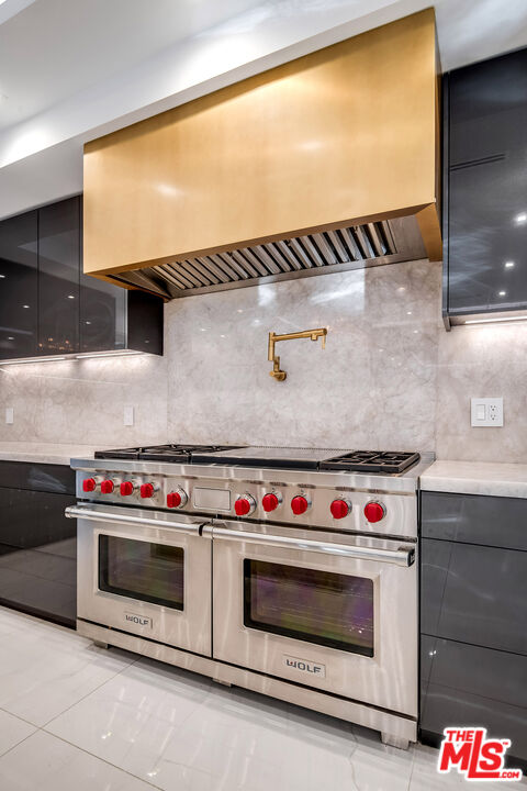 16601 Park Ln Circle Los Angeles, CA 90049 - Photo 31 of 69 a stove top oven sitting inside of a kitchen
