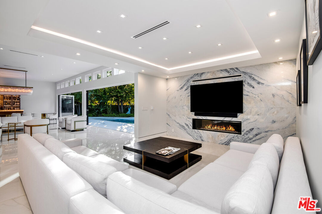 16601 Park Ln Circle Los Angeles, CA 90049 - Photo 32 of 69 a living room with furniture and a flat screen tv