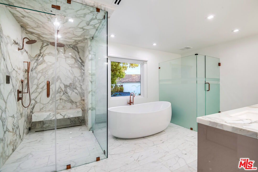 16601 Park Ln Circle Los Angeles, CA 90049 - Photo 40 of 69 a bathroom with a bathtub and shower