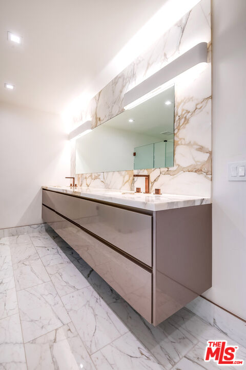 16601 Park Ln Circle Los Angeles, CA 90049 - Photo 41 of 69 a bathroom with a sink and a mirror