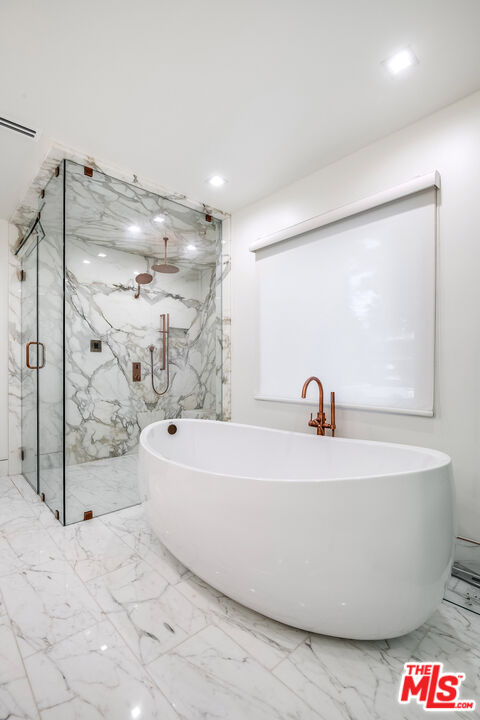 16601 Park Ln Circle Los Angeles, CA 90049 - Photo 42 of 69 a white bath tub sitting in a bathroom