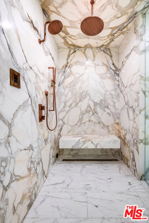 16601 Park Ln Circle Los Angeles, CA 90049 - Photo 43 of 69 a bathroom with a granite countertop sink and a mirror