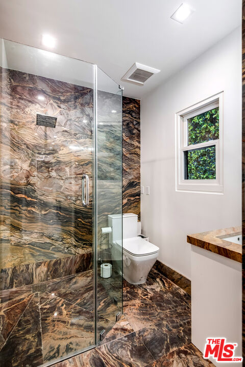 16601 Park Ln Circle Los Angeles, CA 90049 - Photo 47 of 69 a bathroom with a toilet and a shower