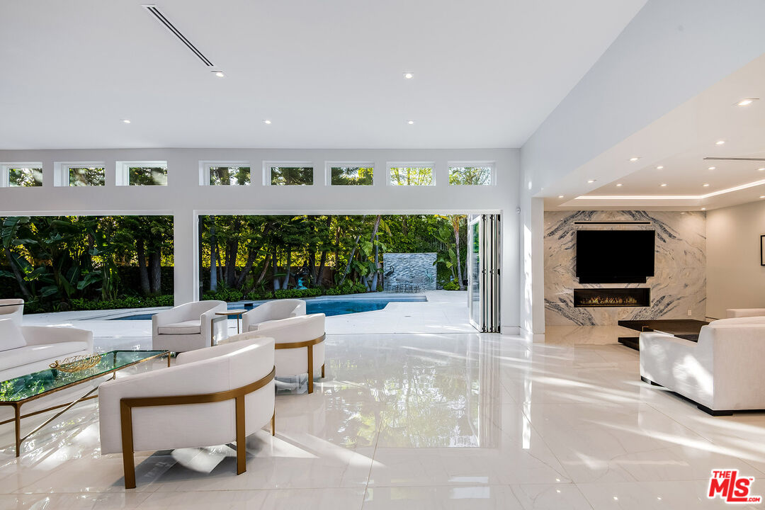 16601 Park Ln Circle Los Angeles, CA 90049 - Photo 5 of 69 a living room with furniture and a flat screen tv