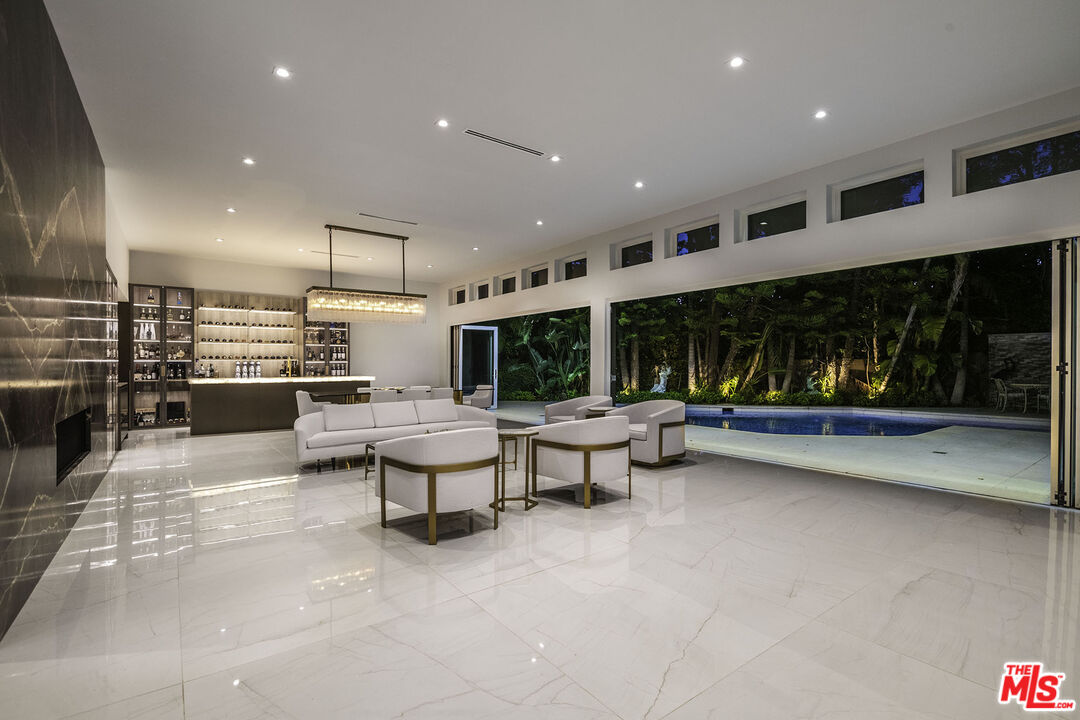 16601 Park Ln Circle Los Angeles, CA 90049 - Photo 54 of 69 a living room with furniture and a large window