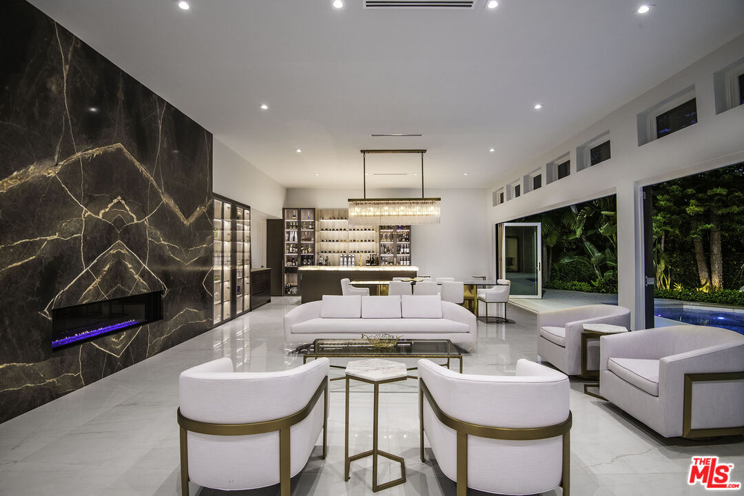 16601 Park Ln Circle Los Angeles, CA 90049 - Photo 55 of 69 a living room with fireplace furniture and a large window