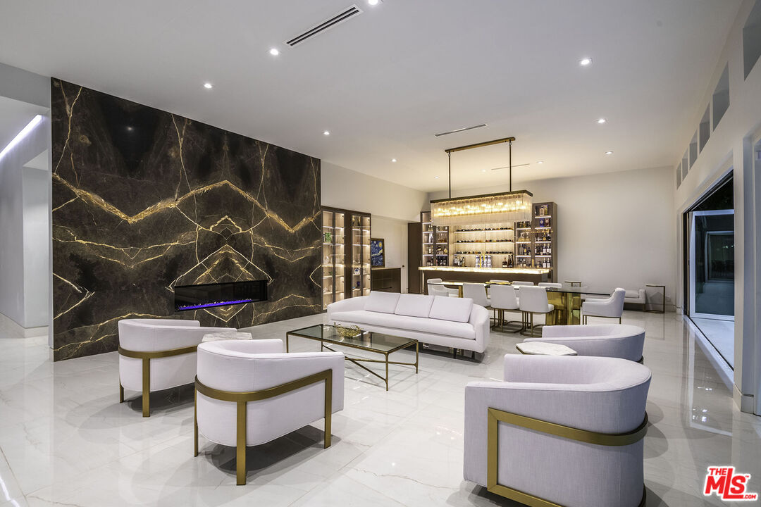 16601 Park Ln Circle Los Angeles, CA 90049 - Photo 56 of 69 a living room with furniture and a flat screen tv