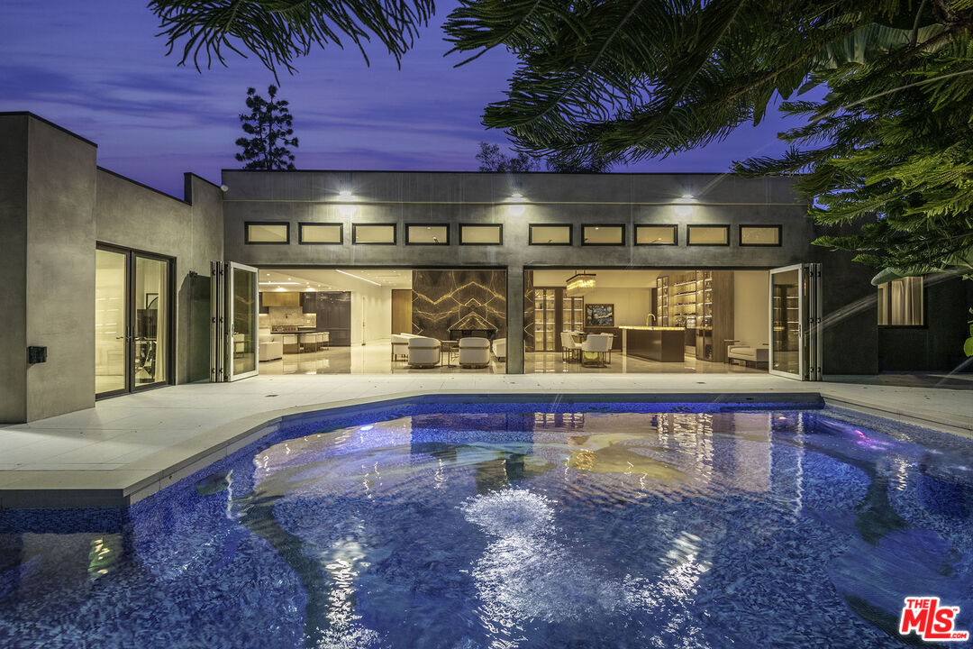 16601 Park Ln Circle Los Angeles, CA 90049 - Photo 60 of 69 a view of a swimming pool with a patio