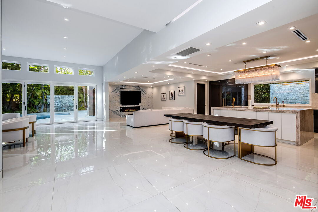 16601 Park Ln Circle Los Angeles, CA 90049 - Photo 6 of 69 a room with lots of furniture and a large window