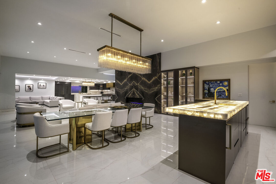 16601 Park Ln Circle Los Angeles, CA 90049 - Photo 61 of 69 a kitchen with a table and chairs in it
