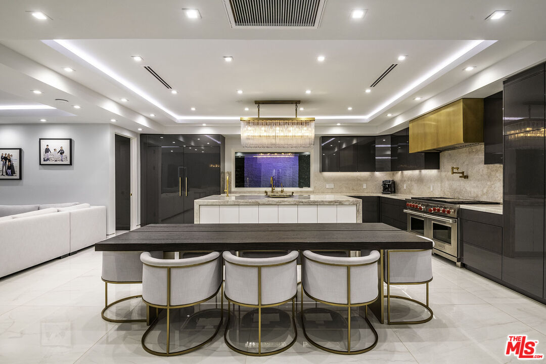 16601 Park Ln Circle Los Angeles, CA 90049 - Photo 64 of 69 a kitchen with a table and chairs in it