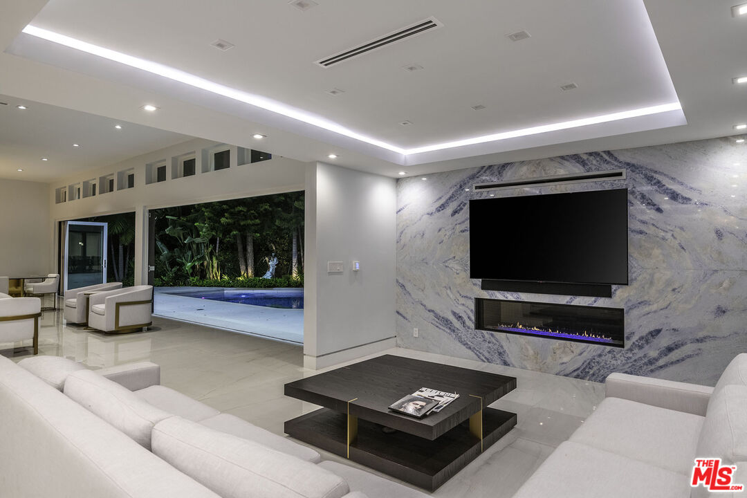 16601 Park Ln Circle Los Angeles, CA 90049 - Photo 67 of 69 a living room with furniture and a flat screen tv