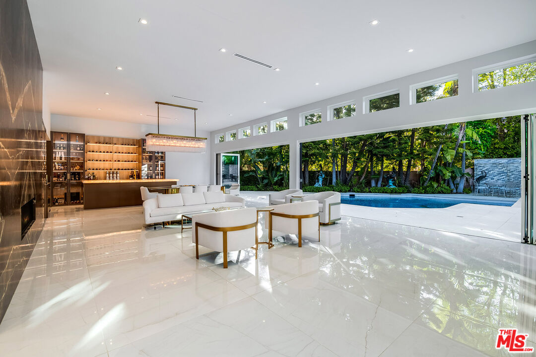 16601 Park Ln Circle Los Angeles, CA 90049 - Photo 7 of 69 a view of a patio with a table and chairs
