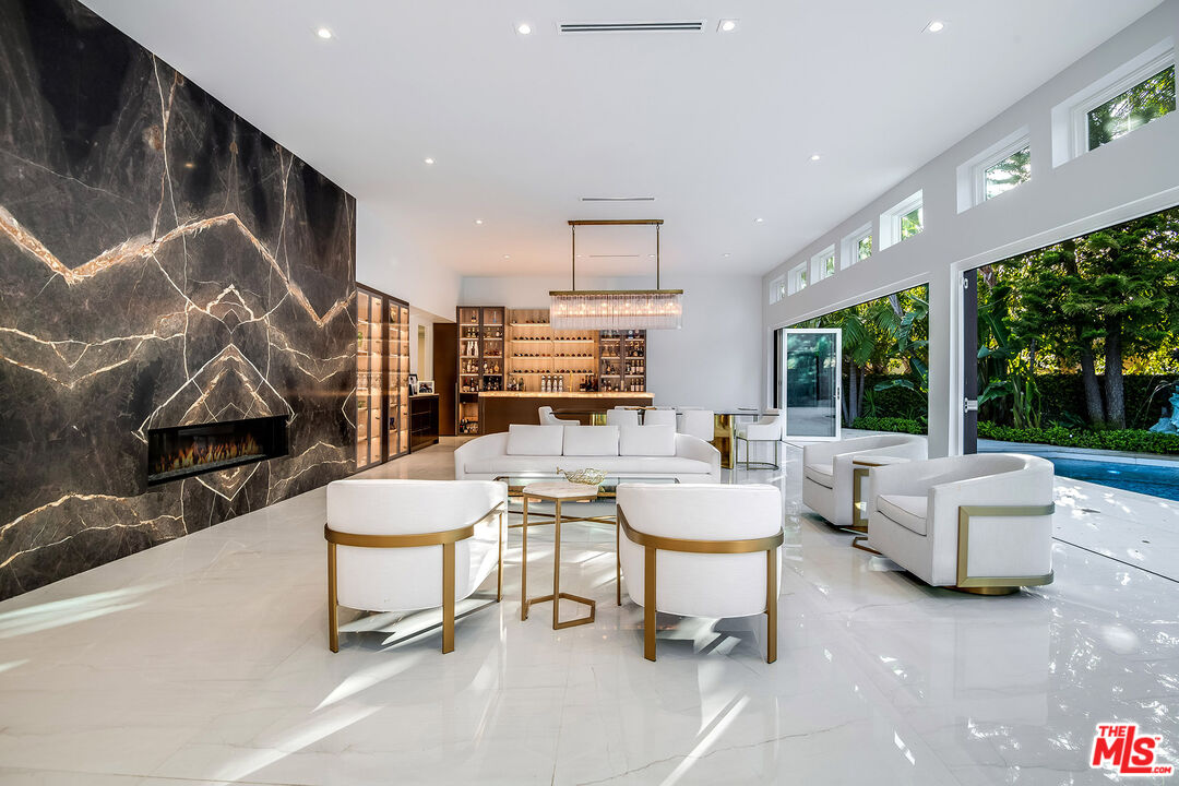 16601 Park Ln Circle Los Angeles, CA 90049 - Photo 8 of 69 a living room with patio furniture and a potted plant