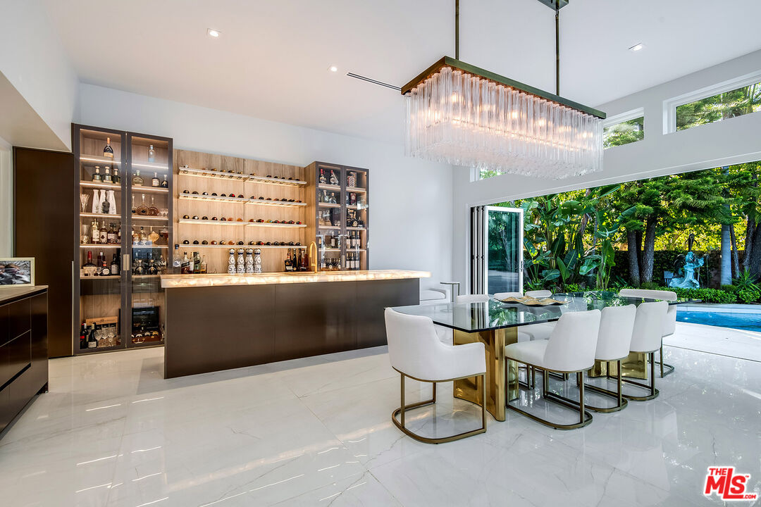 16601 Park Ln Circle Los Angeles, CA 90049 - Photo 9 of 69 a living room with furniture a fireplace and a flat screen tv