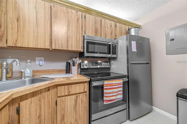 a kitchen with a refrigerator sink and microwave