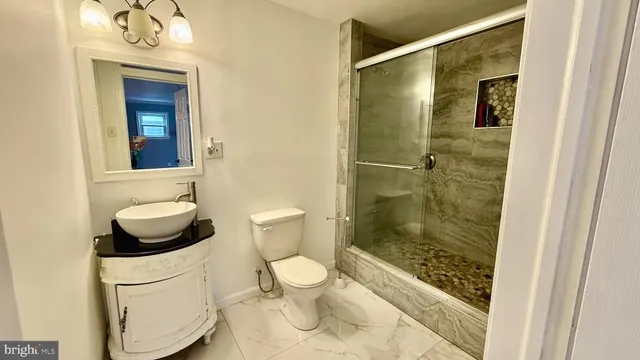 a bathroom with a toilet and a shower
