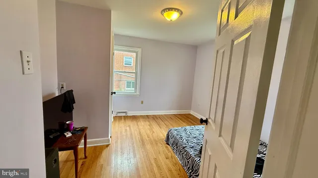 a view of a livingroom with wooden floor and a flat screen tv