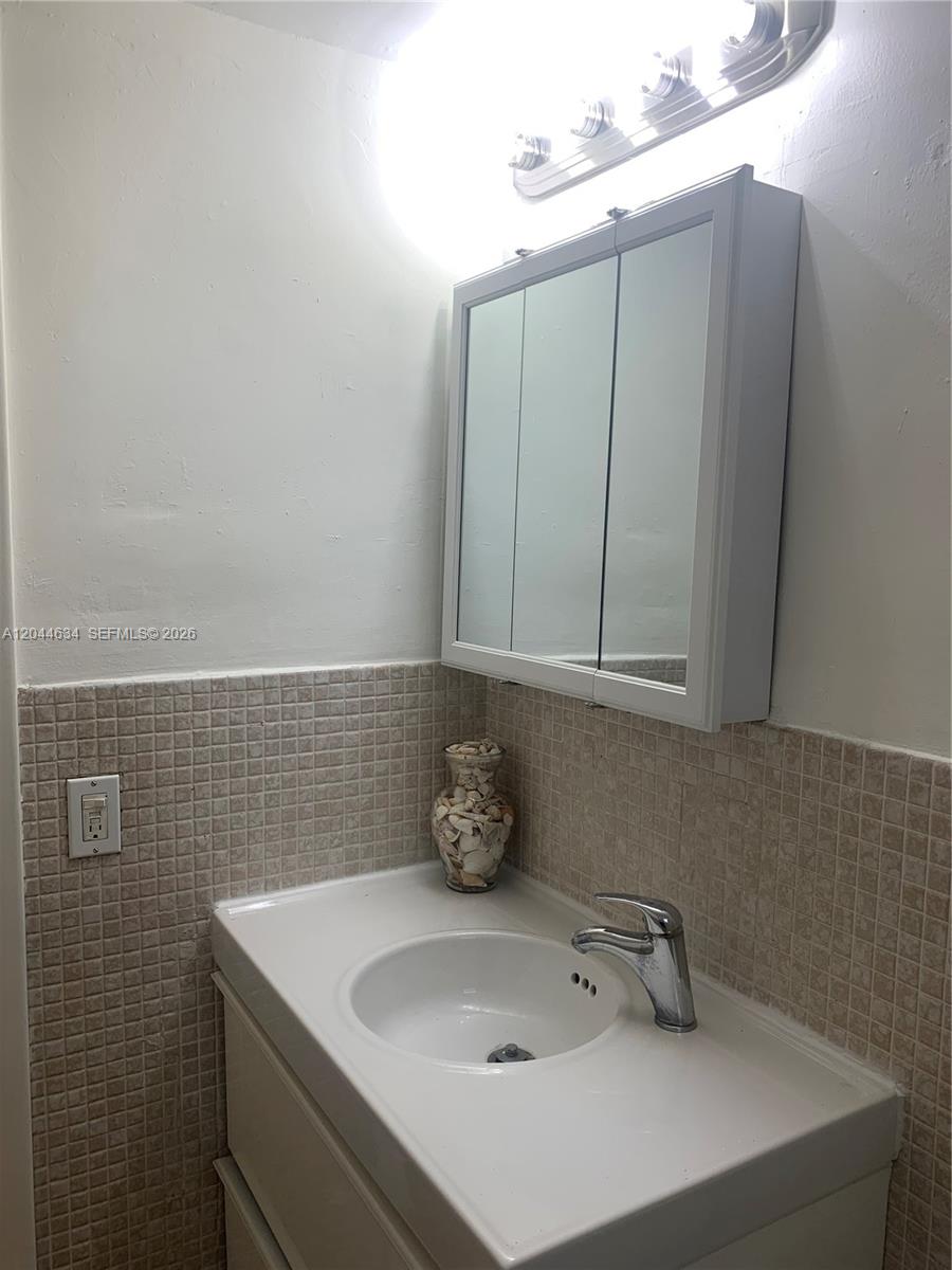 2460 Southwest 18th Avenue, Unit 1205 Miami, FL 33133 - Photo 16 of 21 a bathroom with a sink and a window