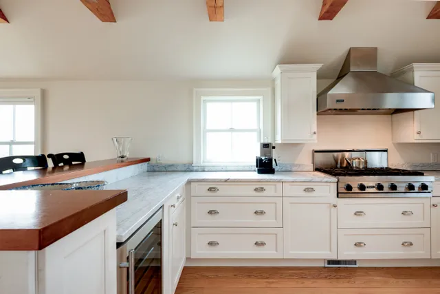 a kitchen with cabinets appliances a sink and a stove