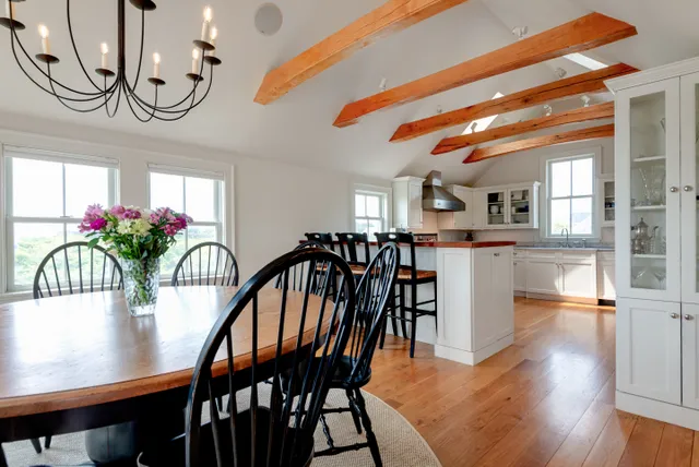 a dining room with furniture and wooden floor