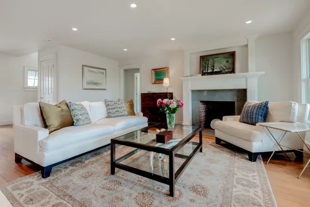 a living room with furniture a fireplace and a flat screen tv