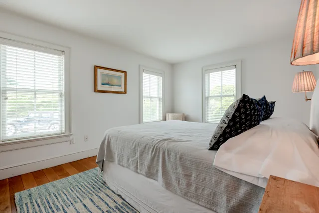 a bed sitting in a bedroom next to a window