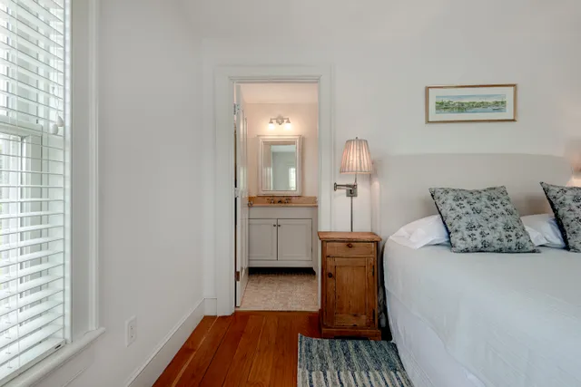 a bedroom with a bed and a view of kitchen