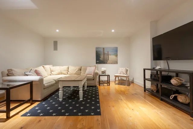 a living room with furniture and a flat screen tv