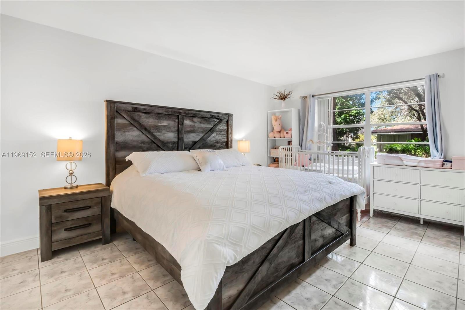 8501 Northwest 8th Street, Unit 110 Miami, FL 33126 - Photo 11 of 21 a bedroom with a bed and a window