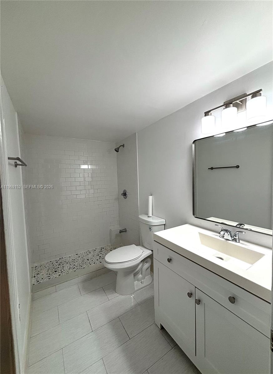 8501 Northwest 8th Street, Unit 110 Miami, FL 33126 - Photo 9 of 21 a bathroom with a toilet sink and mirror