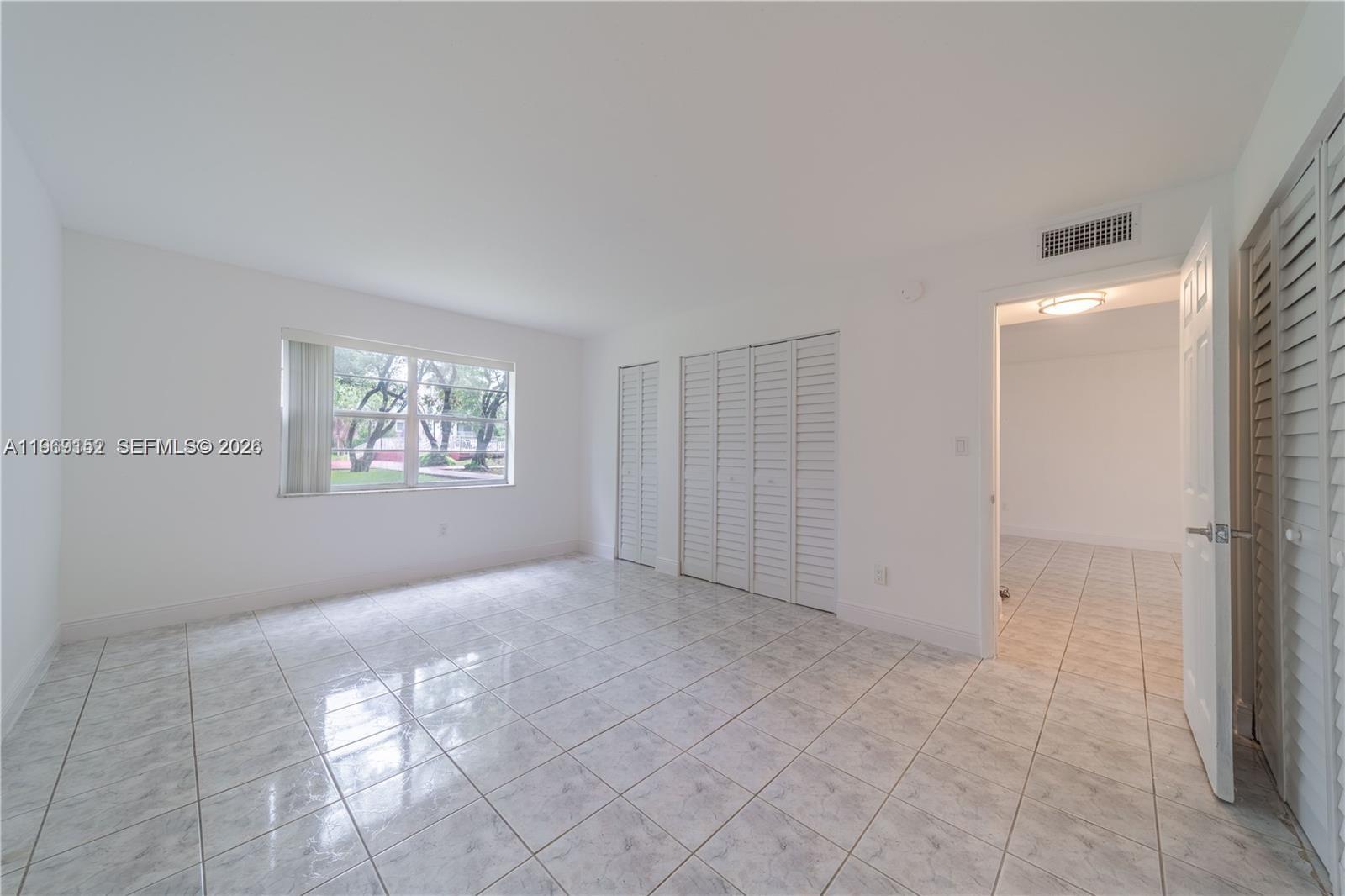 8501 Northwest 8th Street, Unit 110 Miami, FL 33126 - Photo 10 of 21 a view of an empty room with a window