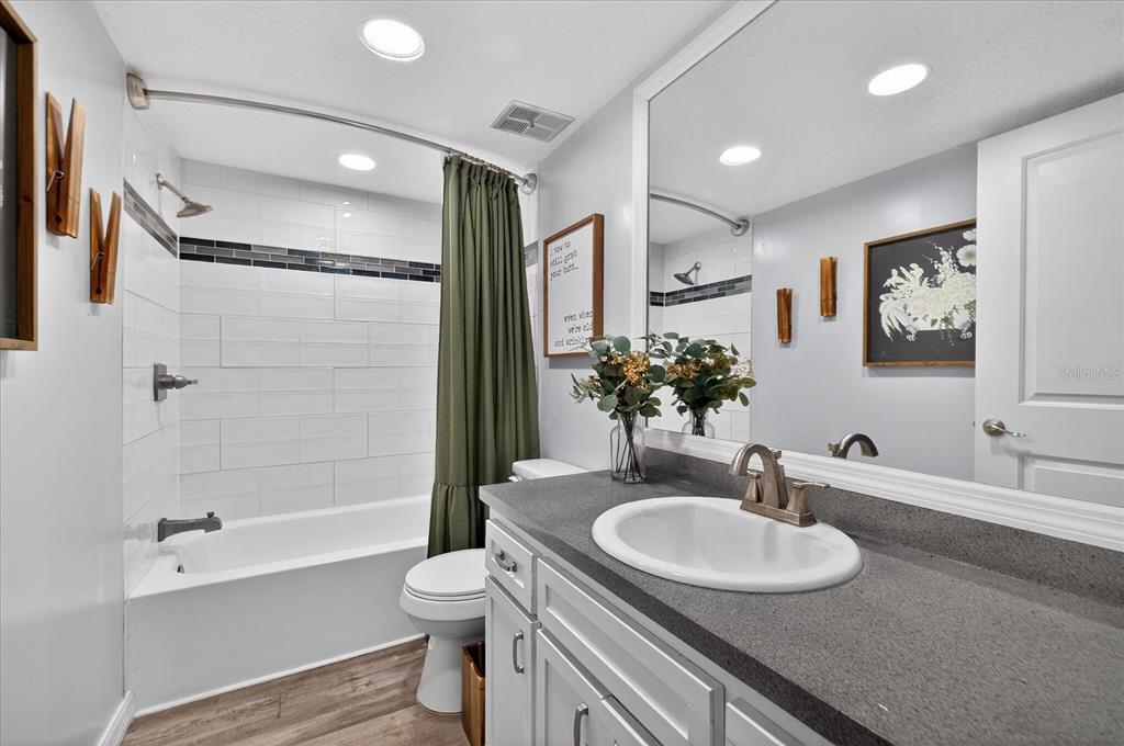 3230 Teeside Drive New Port Richey, FL 34655 - Photo 17 of 32 a bathroom with a granite countertop sink toilet and shower