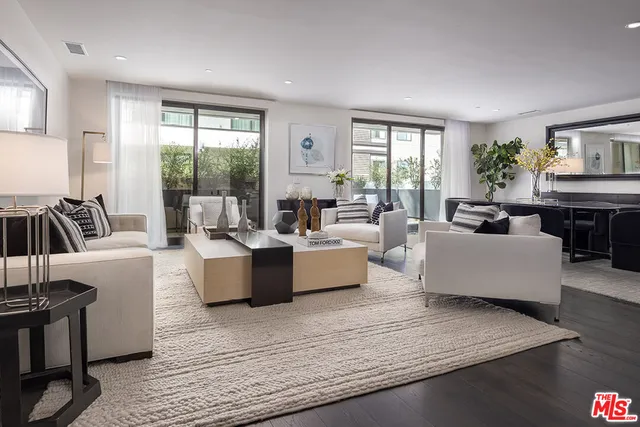 a living room with fireplace furniture and a large window