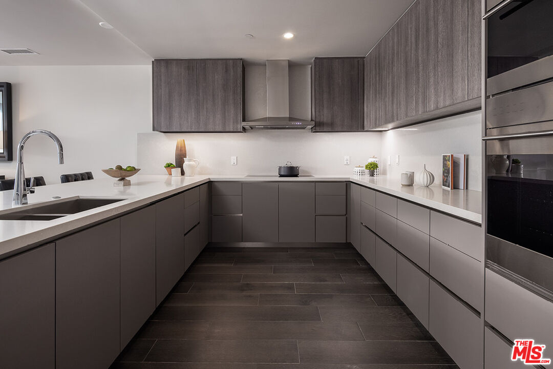 411 South Hamel Road, Unit 205 Los Angeles, CA 90048 - Photo 5 of 17 a kitchen with stainless steel appliances granite countertop a sink stove and cabinets