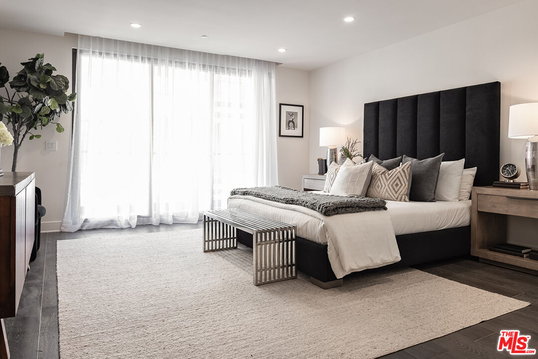 411 South Hamel Road, Unit 205 Los Angeles, CA 90048 - Photo 6 of 17 a spacious bedroom with a bed and a window