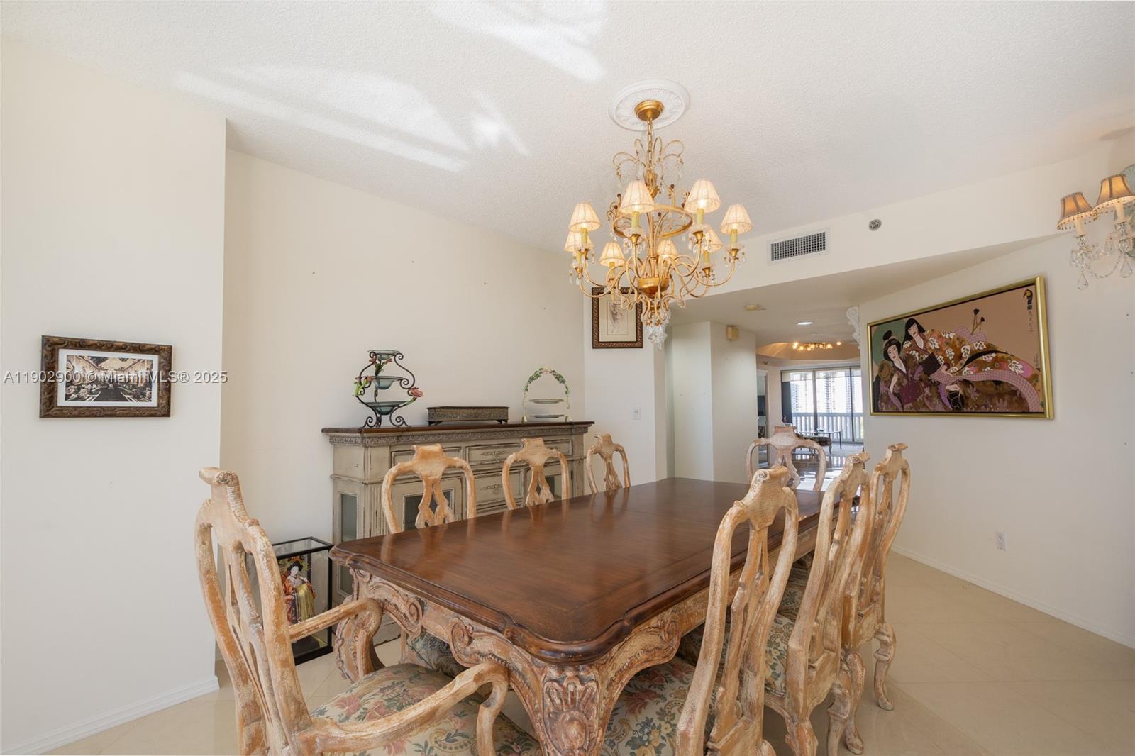 2000 Island Boulevard, Unit 1109 Aventura, FL 33160 - Photo 11 of 13 a view of a dining room with furniture and chandelier