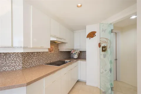 a kitchen with a refrigerator and cabinets