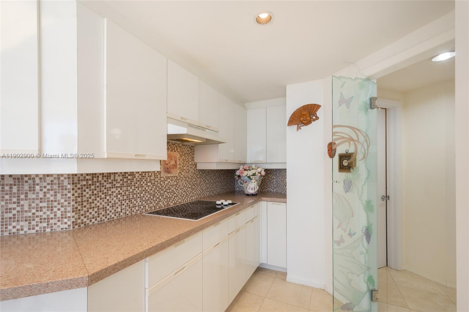 2000 Island Boulevard, Unit 1109 Aventura, FL 33160 - Photo 13 of 13 a kitchen with a refrigerator and cabinets