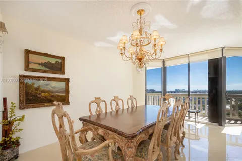 a view of a dining room with furniture wooden floor and chandelier