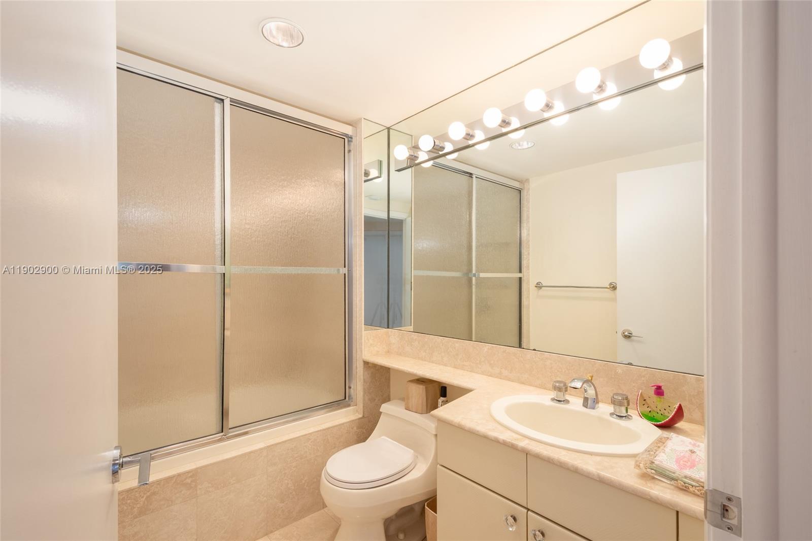 2000 Island Boulevard, Unit 1109 Aventura, FL 33160 - Photo 8 of 13 a bathroom with a sink toilet and shower