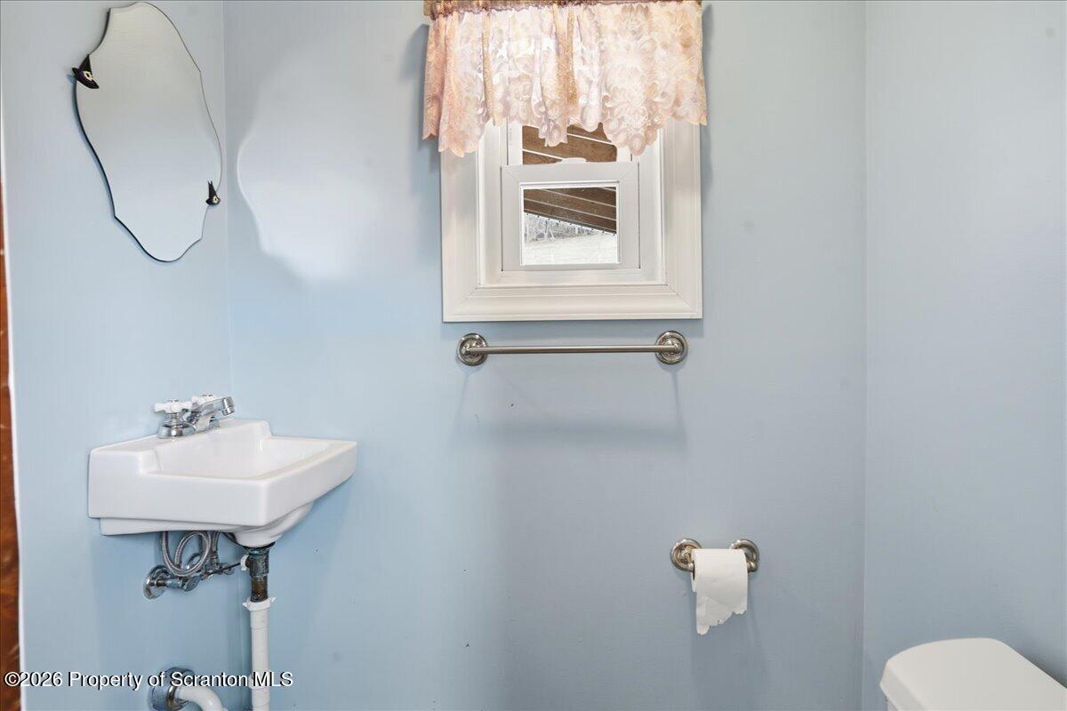 795 Wescott Road New Milford, PA 18834 - Photo 37 of 81 a bathroom with a sink toilet and a mirror