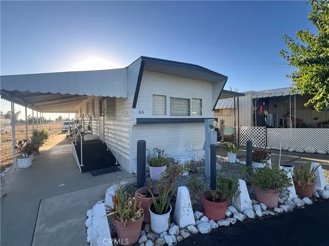 a building outdoor space with patio furniture and potted plants