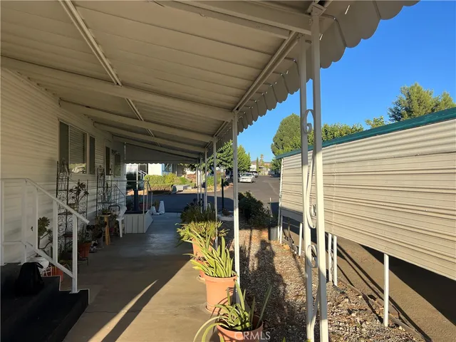 a view of a patio with table and chairs and potted plants